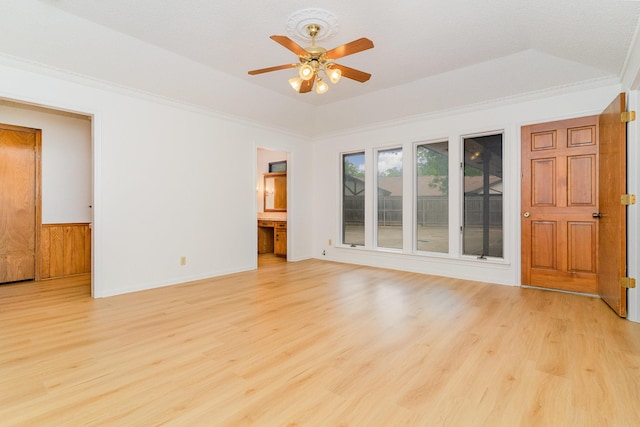 3004 Glasgow Dr, Arlington, TX 76015 - unfurnished room with light wood-style floors, a ceiling fan, a raised ceiling, a wainscoted wall, and ornamental molding