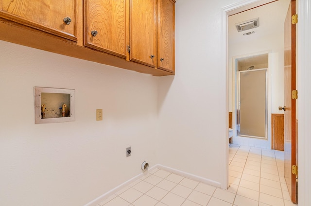 3004 Glasgow Dr, Arlington, TX 76015 - laundry room with hookup for an electric dryer, hookup for a washing machine, cabinet space, and light tile patterned flooring