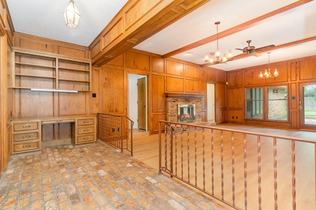 3004 Glasgow Dr, Arlington, TX 76015 - kitchen featuring a chandelier, wood walls, built in desk, beamed ceiling, and hanging light fixtures