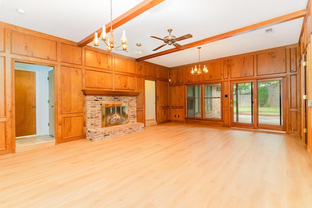 3004 Glasgow Dr, Arlington, TX 76015 - unfurnished living room with a chandelier, a fireplace, light wood finished floors, wooden walls, and a ceiling fan