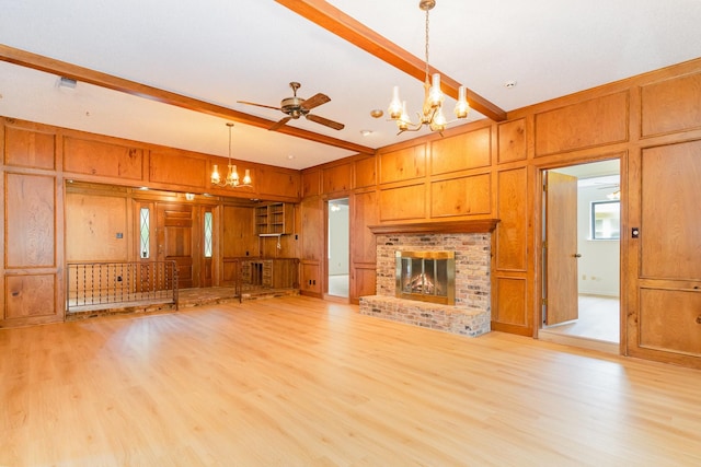 3004 Glasgow Dr, Arlington, TX 76015 - unfurnished living room featuring a chandelier, a decorative wall, light wood-style floors, wood walls, and a fireplace