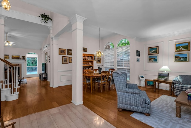 4316 Turnberry Ct, Plano, TX 75024 - living area with decorative columns, a chandelier, vaulted ceiling, a ceiling fan, and wood finished floors