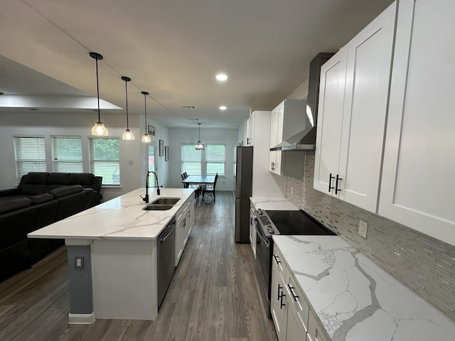 2352 Wynchase Ln, Crandall, TX 75114 - kitchen featuring stainless steel appliances, wall chimney range hood, a center island with sink, open floor plan, and decorative backsplash