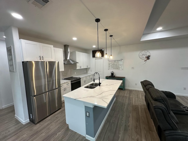 2352 Wynchase Ln, Crandall, TX 75114 - kitchen with freestanding refrigerator, wall chimney range hood, black / electric stove, dark wood-type flooring, and recessed lighting
