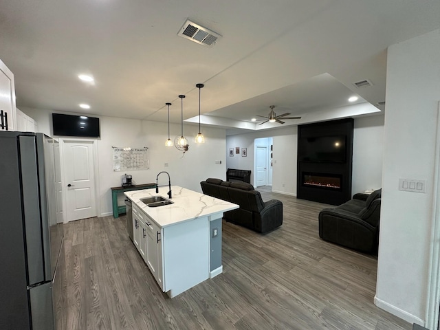 2352 Wynchase Ln, Crandall, TX 75114 - kitchen with appliances with stainless steel finishes, ceiling fan, white cabinets, dark wood-style floors, and open floor plan