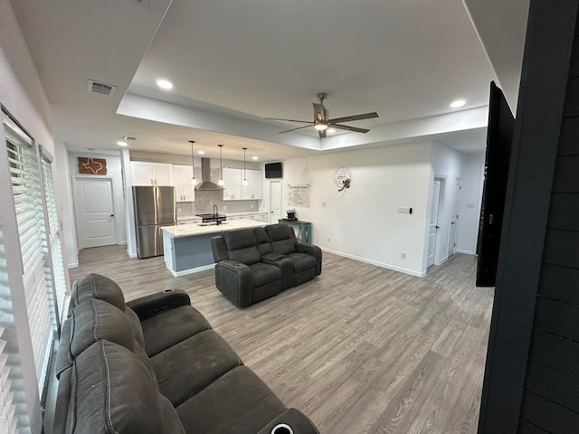 2352 Wynchase Ln, Crandall, TX 75114 - living area with a tray ceiling, a ceiling fan, light wood-style flooring, and recessed lighting