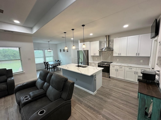 2352 Wynchase Ln, Crandall, TX 75114 - kitchen featuring wall chimney exhaust hood, appliances with stainless steel finishes, white cabinets, wood finished floors, and recessed lighting