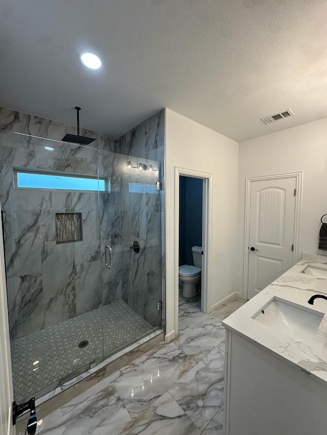 2352 Wynchase Ln, Crandall, TX 75114 - bathroom featuring marble look tiles, a marble finish shower, double vanity, recessed lighting, and a textured ceiling