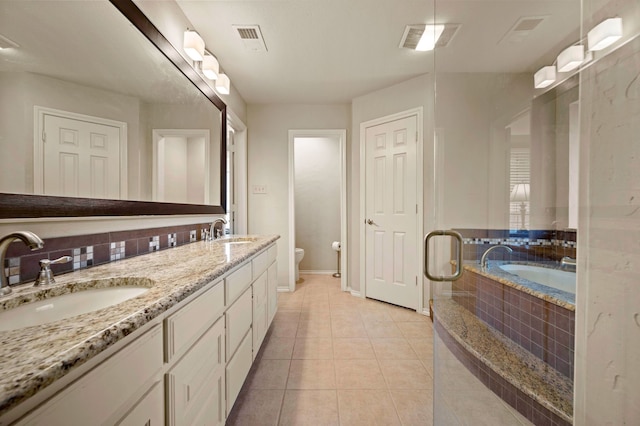 3121 Oakdale Dr, Hurst, TX 76054 - bathroom featuring a bath, double vanity, and tile patterned floors