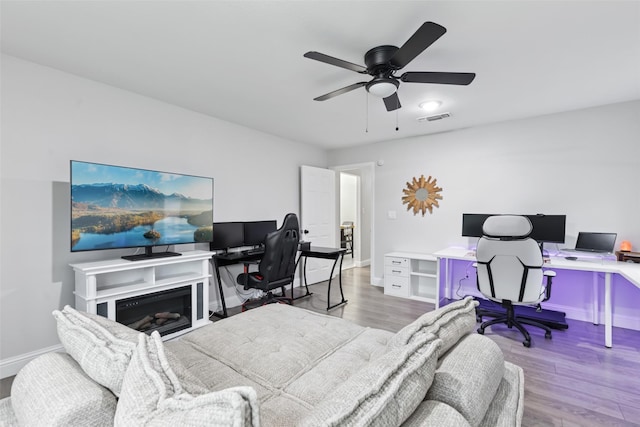 348 Thompson St, Fort Worth, TX 76134 - bedroom with an office area, wood finished floors, and a ceiling fan