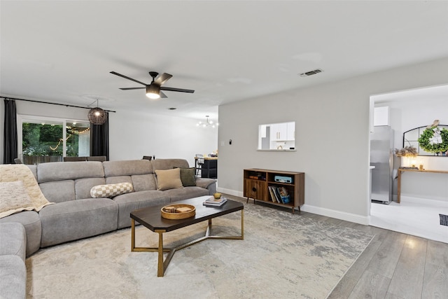 348 Thompson St, Fort Worth, TX 76134 - living area featuring wood finished floors, a chandelier, and ceiling fan