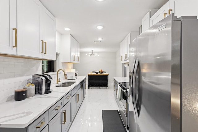 348 Thompson St, Fort Worth, TX 76134 - kitchen featuring stainless steel appliances, light marble finish floors, backsplash, light stone counters, and white cabinets