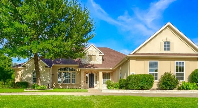 305 Wood Duck Ln, Mckinney, TX 75072 - view of front facade with a front yard, stucco siding, and stone siding