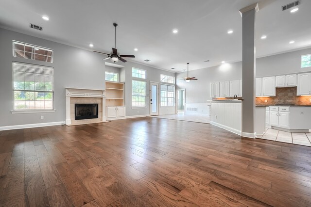 305 Wood Duck Ln, Mckinney, TX 75072 - unfurnished living room with ceiling fan, light wood-type flooring, a tile fireplace, recessed lighting, and ornamental molding