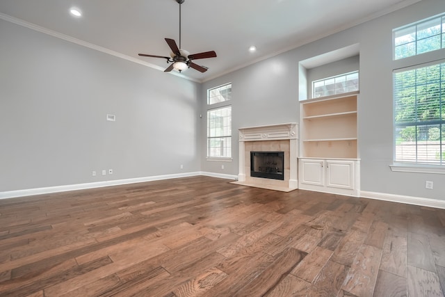 305 Wood Duck Ln, Mckinney, TX 75072 - unfurnished living room with crown molding, dark wood-type flooring, ceiling fan, a tile fireplace, and recessed lighting