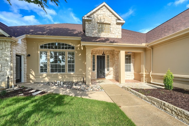 305 Wood Duck Ln, Mckinney, TX 75072 - property entrance with stone siding, stucco siding, and a shingled roof