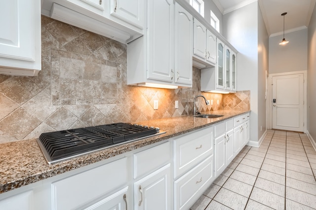 305 Wood Duck Ln, Mckinney, TX 75072 - kitchen with stainless steel gas stovetop, ornamental molding, glass insert cabinets, decorative backsplash, and white cabinets