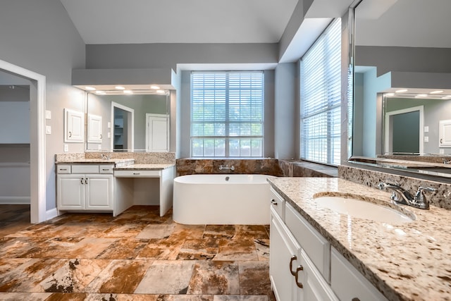 305 Wood Duck Ln, Mckinney, TX 75072 - bathroom featuring plenty of natural light, a freestanding tub, two vanities, and lofted ceiling