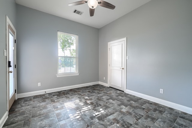 305 Wood Duck Ln, Mckinney, TX 75072 - spare room featuring ceiling fan and dark stone finish flooring