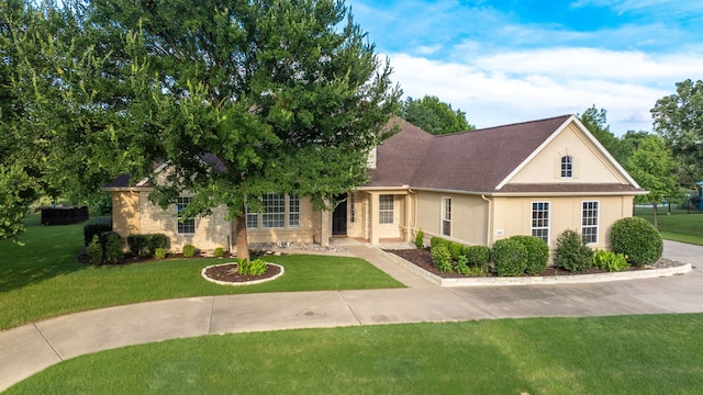 305 Wood Duck Ln, Mckinney, TX 75072 - view of front of house with stucco siding, a front yard, and a shingled roof