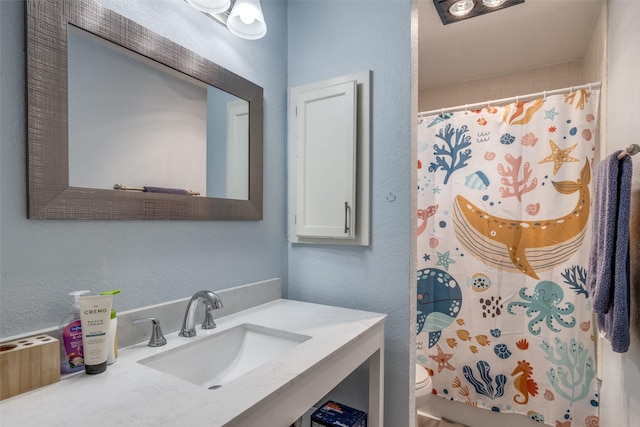 212 Valley Spring Dr, Arlington, TX 76018 - bathroom with vanity, curtained shower, and a textured wall
