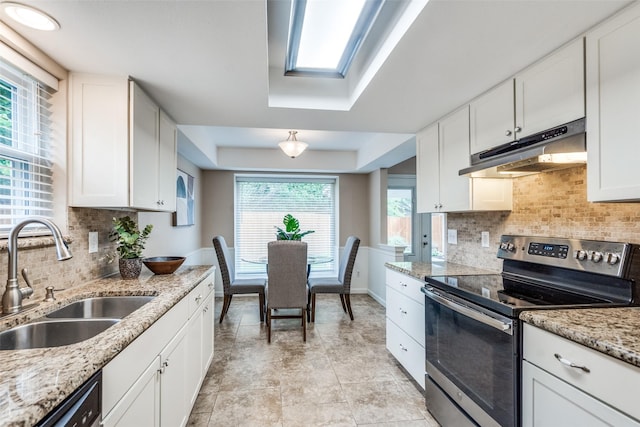 8688 Grenadier Ct, Dallas, TX 75238 - kitchen with stainless steel electric stove, under cabinet range hood, white cabinets, dishwasher, and decorative backsplash