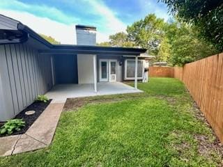 8688 Grenadier Ct, Dallas, TX 75238 - rear view of house featuring a chimney, a fenced backyard, a patio area, and board and batten siding