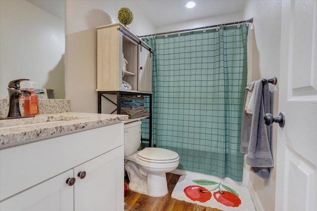 311 W Oak St, Whitewright, TX 75491 - full bathroom with vanity, a shower with shower curtain, wood finished floors, and recessed lighting