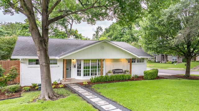 7845 Blackbird Ln, Dallas, TX 75238 - ranch-style home with a shingled roof, brick siding, and a porch