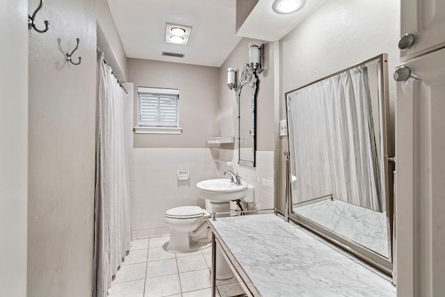 7845 Blackbird Ln, Dallas, TX 75238 - full bathroom with tile patterned floors, a shower with shower curtain, tile walls, and wainscoting