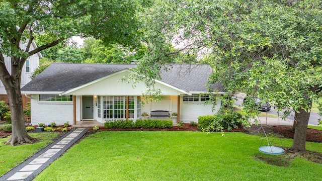 7845 Blackbird Ln, Dallas, TX 75238 - ranch-style home with a shingled roof, brick siding, a front yard, and covered porch