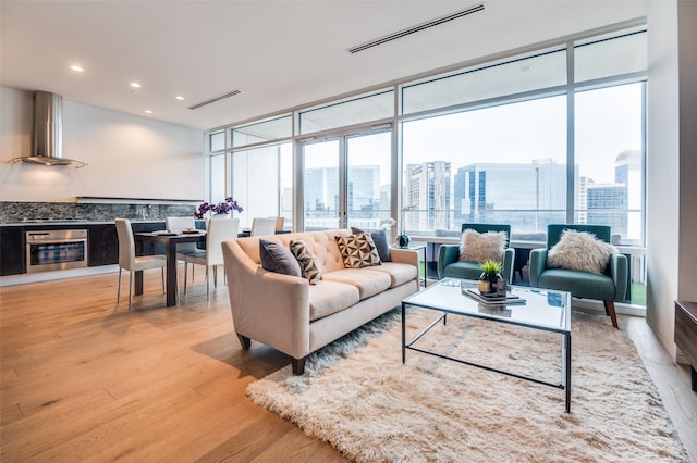 2430 Victory Park Ln Unit 1906, Dallas, TX 75219 - living area featuring expansive windows, plenty of natural light, wood finished floors, a view of city, and recessed lighting