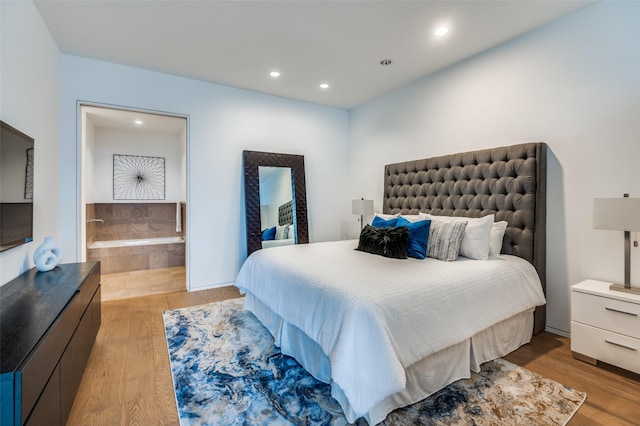 2430 Victory Park Ln Unit 1906, Dallas, TX 75219 - bedroom with light wood-type flooring, recessed lighting, and ensuite bathroom