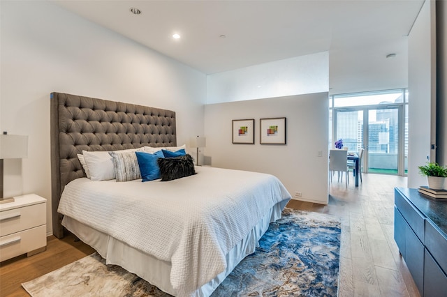 2430 Victory Park Ln Unit 1906, Dallas, TX 75219 - bedroom featuring wood finished floors and recessed lighting
