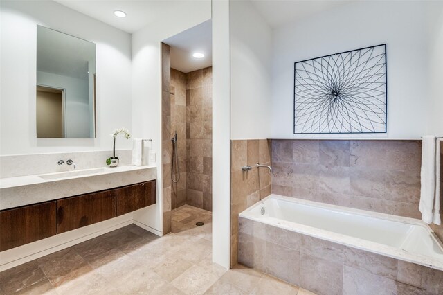 2430 Victory Park Ln Unit 1906, Dallas, TX 75219 - bathroom featuring a bath, walk in shower, vanity, and recessed lighting