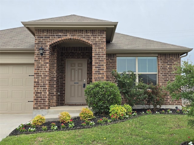 408 Citation Ln, Ponder, TX 76259 - entrance to property featuring brick siding, a garage, roof with shingles, and concrete driveway