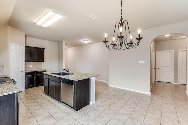 408 Citation Ln, Ponder, TX 76259 - kitchen featuring stainless steel dishwasher, arched walkways, hanging light fixtures, an island with sink, and backsplash
