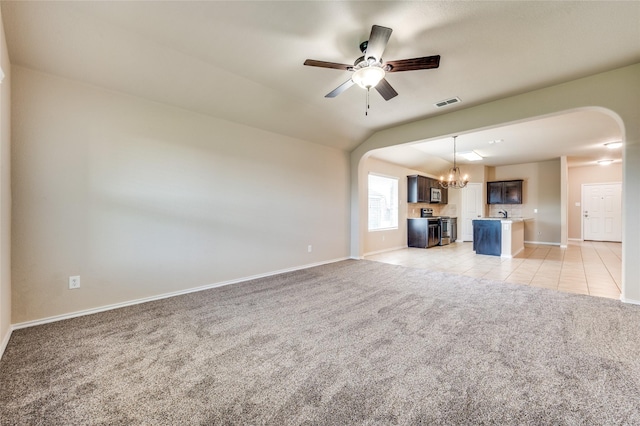 408 Citation Ln, Ponder, TX 76259 - unfurnished living room with light carpet, arched walkways, a ceiling fan, a chandelier, and vaulted ceiling