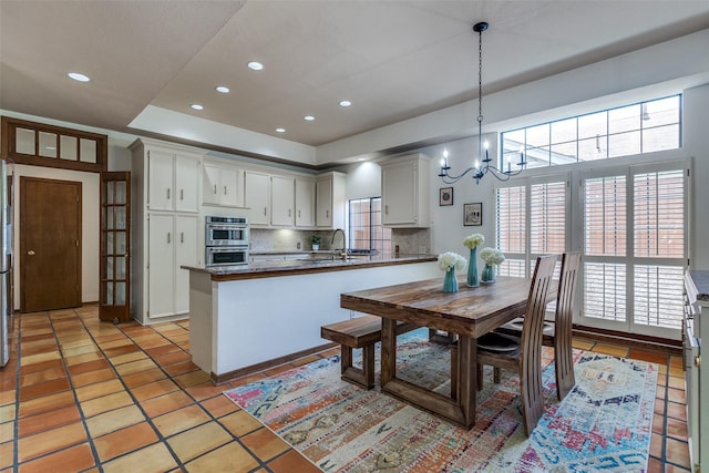 1507 Abrams Rd, Dallas, TX 75214 - dining room featuring a chandelier, plenty of natural light, recessed lighting, and light tile patterned floors