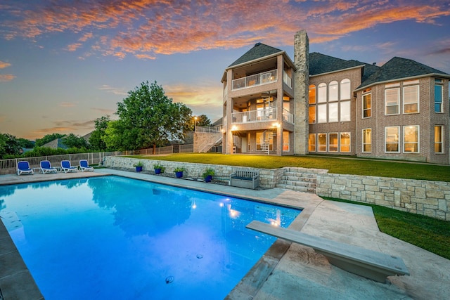 8800 Summit Point Ct, Fort Worth, TX 76179 - back of house at dusk featuring stairs, a fenced backyard, a patio area, and a balcony