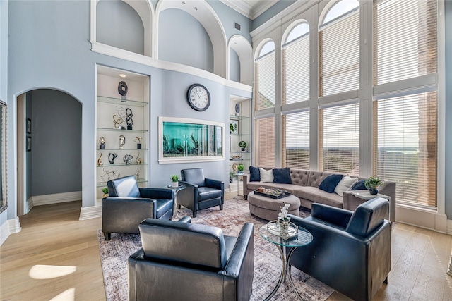 8800 Summit Point Ct, Fort Worth, TX 76179 - living area featuring a high ceiling, healthy amount of natural light, built in shelves, light wood-type flooring, and crown molding