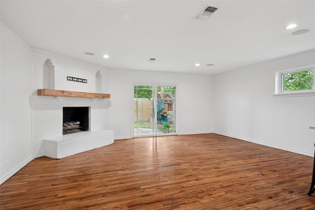 522 Carol Ct, Richardson, TX 75081 - unfurnished living room with plenty of natural light, wood finished floors, a fireplace, and recessed lighting