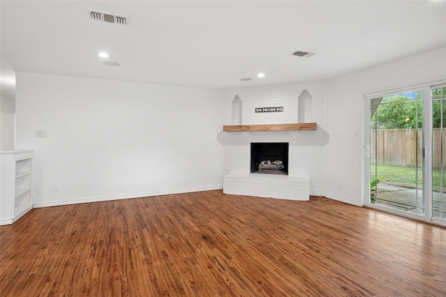 522 Carol Ct, Richardson, TX 75081 - unfurnished living room with wood finished floors, a fireplace, and recessed lighting
