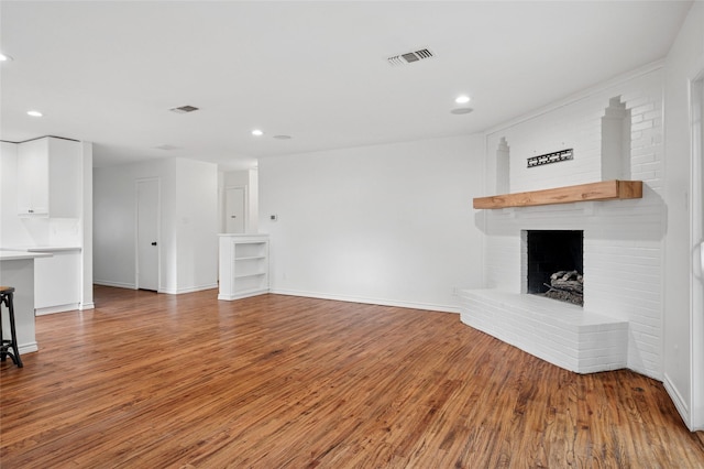 522 Carol Ct, Richardson, TX 75081 - unfurnished living room featuring light wood finished floors, recessed lighting, and a brick fireplace