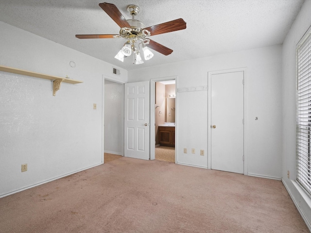 713 Brookhaven Dr, Royse City, TX 75189 - unfurnished bedroom featuring carpet floors, a textured ceiling, ensuite bathroom, and a ceiling fan