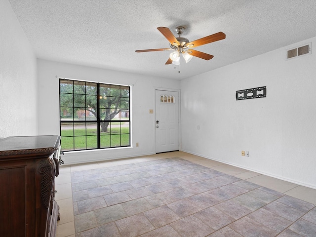 713 Brookhaven Dr, Royse City, TX 75189 - entryway featuring a textured ceiling, a ceiling fan, and light tile patterned floors