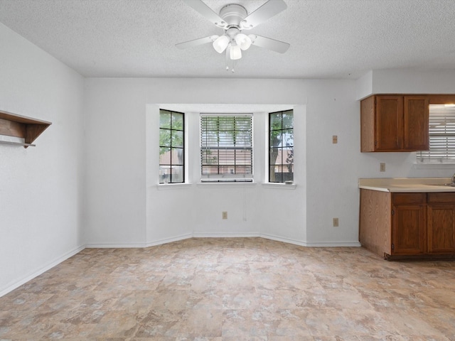 713 Brookhaven Dr, Royse City, TX 75189 - unfurnished dining area featuring a textured ceiling and a ceiling fan