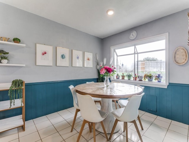 417 Merriman Dr, Highland Village, TX 75077 - dining room featuring a wainscoted wall, light tile patterned floors, and wooden walls