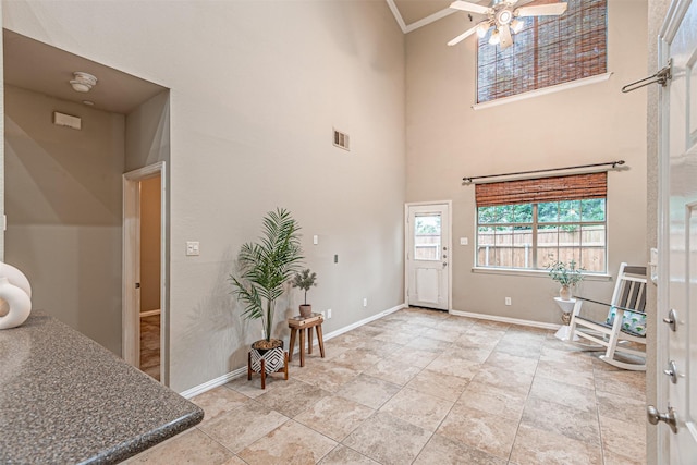 2268 Fletcher Trl, Plano, TX 75025 - foyer entrance with a ceiling fan, a towering ceiling, and ornamental molding