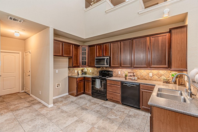 2268 Fletcher Trl, Plano, TX 75025 - kitchen with black appliances, tasteful backsplash, and glass insert cabinets